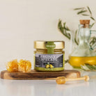 Alemany  glas med Olimel – honning og olivenolie i perfekt harmoni på et bord . Honningcreme. 